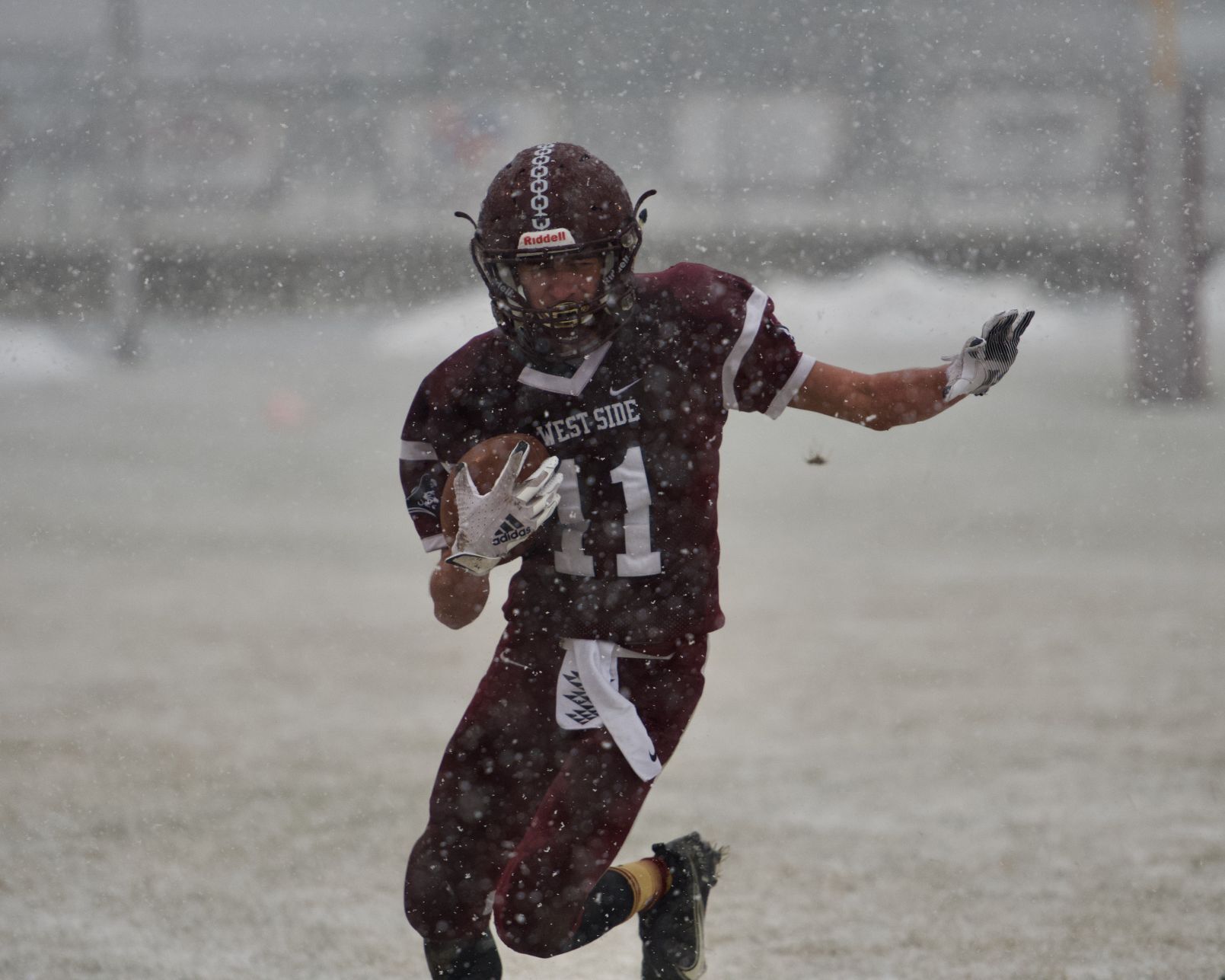 Josh Reeder works his way through the snow for a first down.jpeg